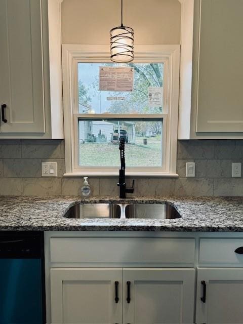 kitchen with white cabinetry, black dishwasher, sink, and pendant lighting