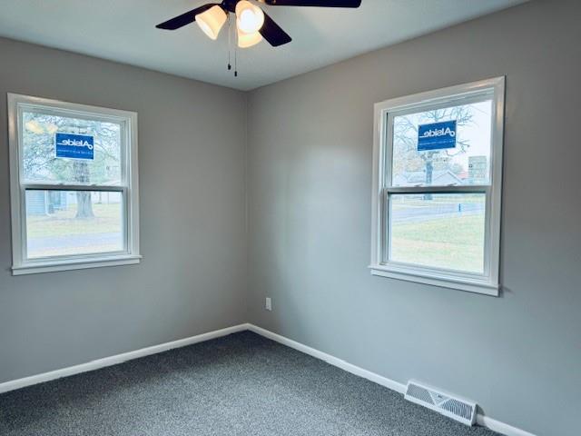 spare room featuring carpet flooring and ceiling fan