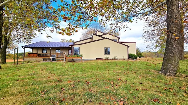 rear view of property with a yard and a wooden deck