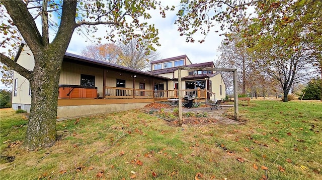 rear view of property featuring a patio, a deck, and a lawn