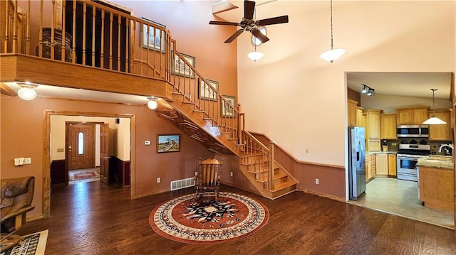 interior space featuring hardwood / wood-style floors, high vaulted ceiling, and sink