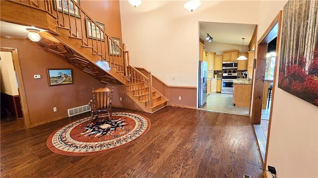 interior space featuring sink, hardwood / wood-style floors, and vaulted ceiling