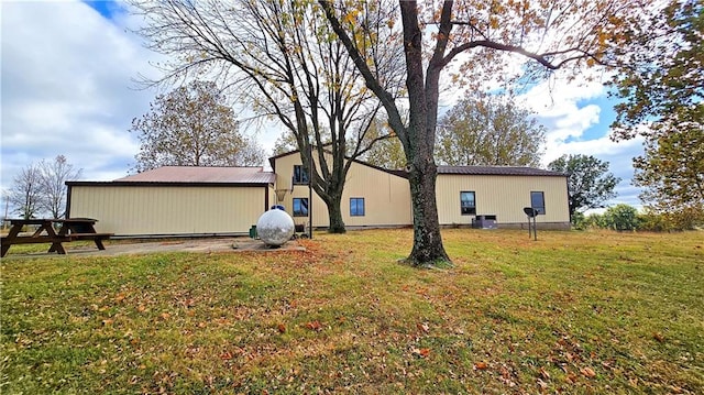 view of side of home with a lawn