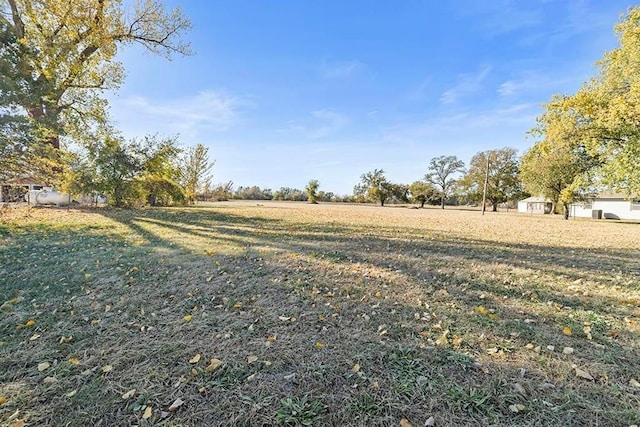 view of yard with a rural view