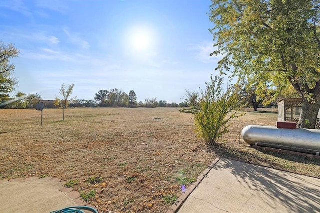 view of yard with a rural view