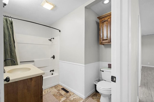 full bathroom with vanity, wood-type flooring, shower / tub combo with curtain, and toilet