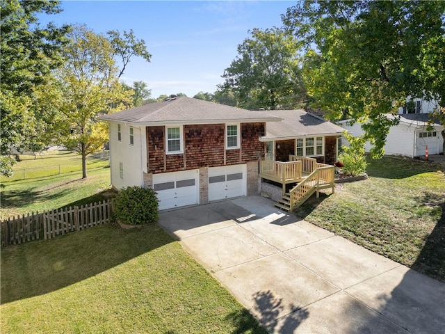 view of front of home with a wooden deck, a front yard, and a garage