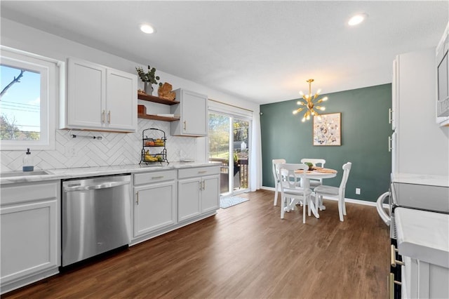 kitchen with white cabinets, dark hardwood / wood-style floors, stainless steel dishwasher, and hanging light fixtures