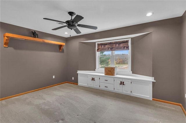 unfurnished bedroom with ceiling fan and light carpet