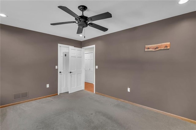 carpeted empty room with ceiling fan