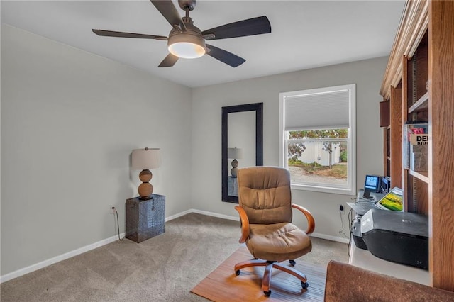 living area with light carpet and ceiling fan