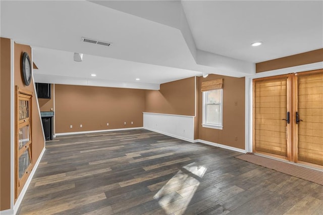 unfurnished living room with dark hardwood / wood-style flooring