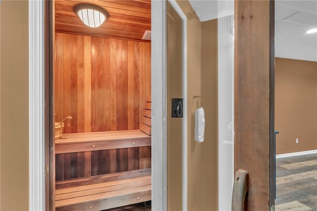 view of sauna / steam room with hardwood / wood-style floors, wooden ceiling, and wood walls