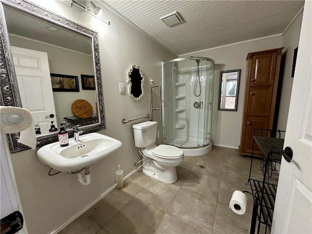 bathroom with tile patterned floors, toilet, an enclosed shower, and crown molding