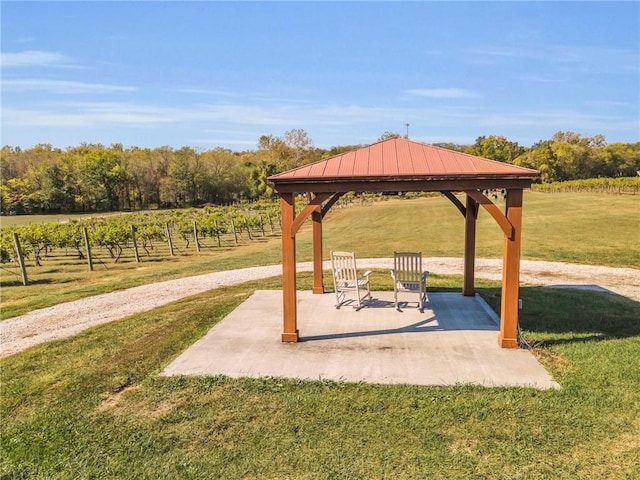 view of property's community featuring a gazebo, a patio area, and a lawn