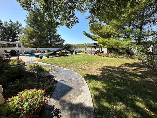 view of yard featuring a gazebo, a patio area, and a fenced in pool