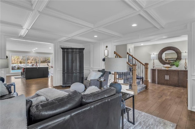 living room featuring beam ceiling, dark wood-type flooring, and coffered ceiling