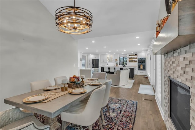 dining room with hardwood / wood-style flooring and a notable chandelier