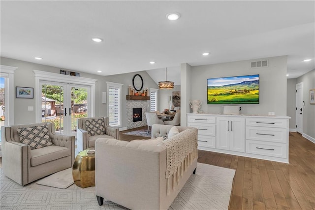 living room featuring french doors and light hardwood / wood-style floors