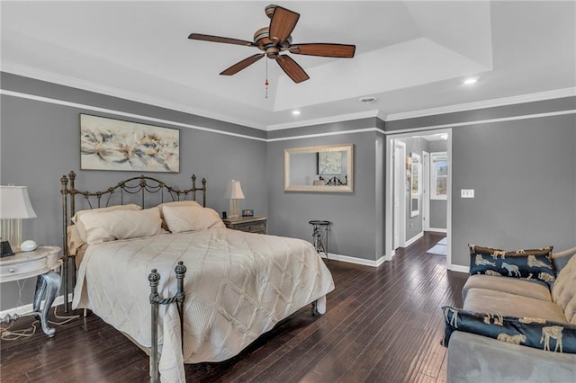 bedroom with a tray ceiling, ceiling fan, dark hardwood / wood-style flooring, and ornamental molding