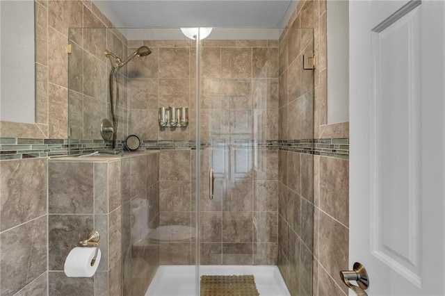 bathroom with tile walls and walk in shower