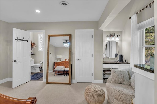 bathroom featuring vanity and toilet