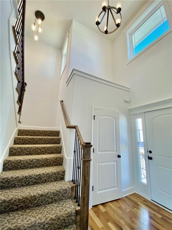 foyer entrance with wood-type flooring and a notable chandelier