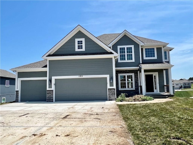 craftsman-style house with a front yard and a garage