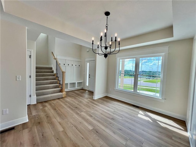 7709 NE 106th Pl, Kansas City, MO 64157 - unfurnished dining area featuring stairs, wood finished floors, and a chandelier