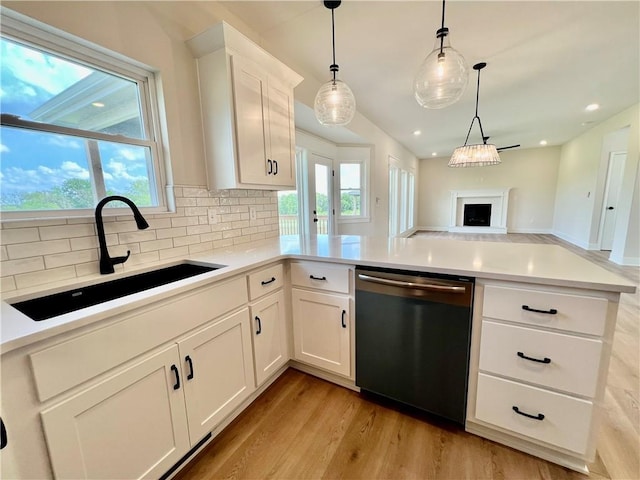 7709 NE 106th Pl, Kansas City, MO 64157 - kitchen with dishwasher, backsplash, open floor plan, light wood finished floors, and pendant lighting