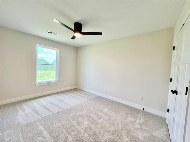 7709 NE 106th Pl, Kansas City, MO 64157 - spare room featuring ceiling fan and light colored carpet