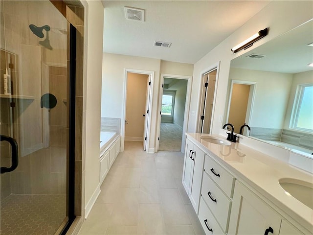 7709 NE 106th Pl, Kansas City, MO 64157 - bathroom featuring a stall shower, a bath, double vanity, and tile patterned floors
