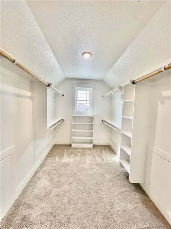 7709 NE 106th Pl, Kansas City, MO 64157 - walk in closet featuring vaulted ceiling and carpet floors