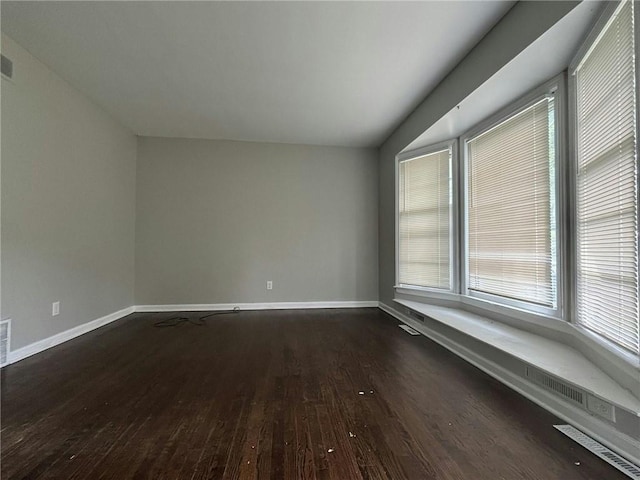 spare room featuring dark hardwood / wood-style flooring