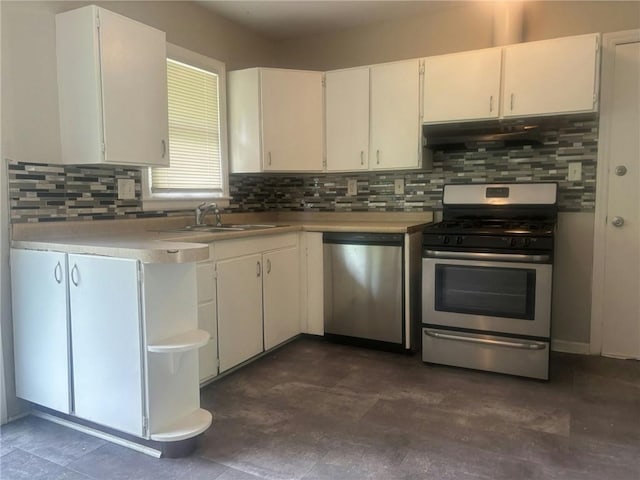 kitchen with stainless steel appliances, decorative backsplash, sink, and white cabinets