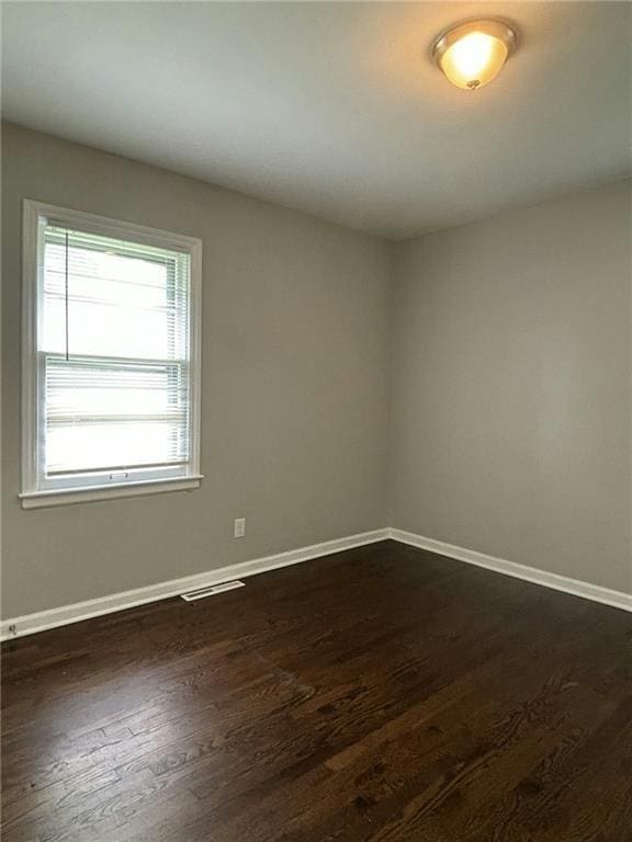 unfurnished room featuring dark hardwood / wood-style floors