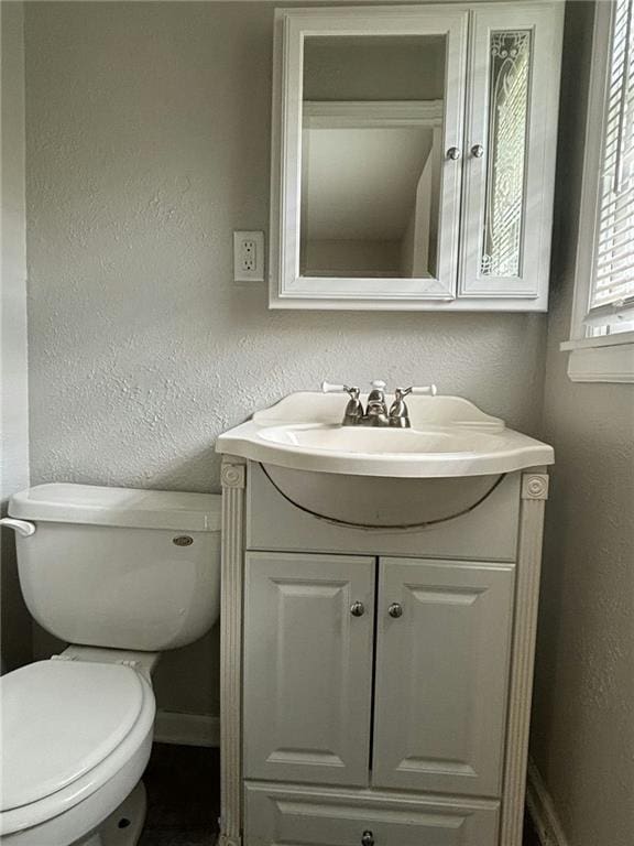 bathroom featuring vanity and toilet