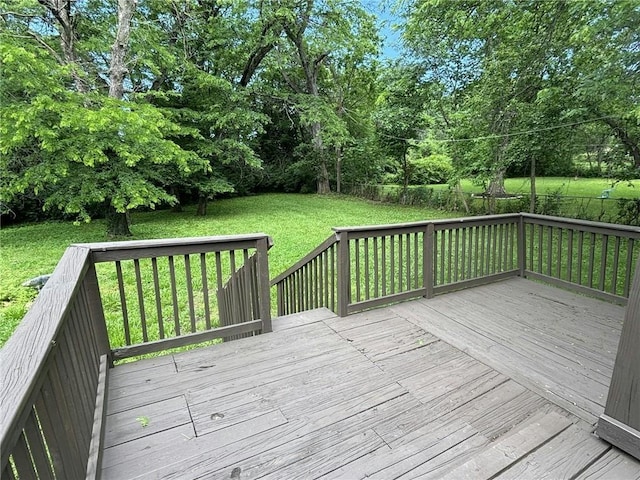 wooden deck featuring a yard