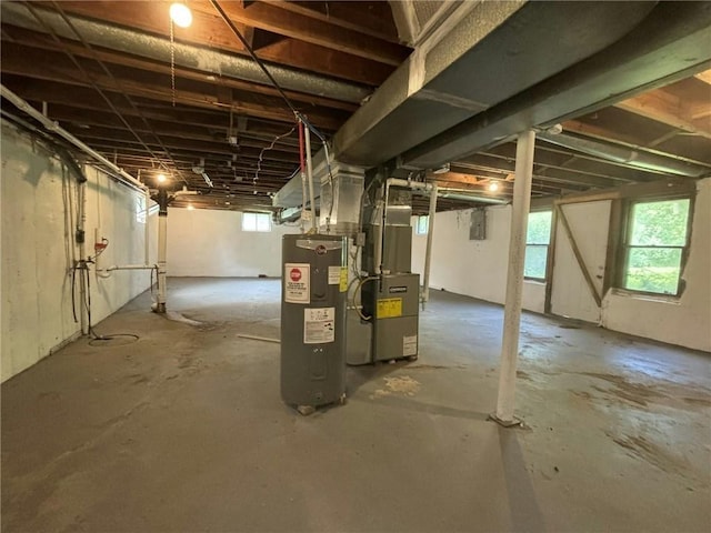 basement featuring electric water heater and heating unit