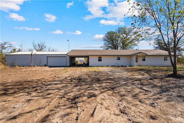 rear view of house with a garage