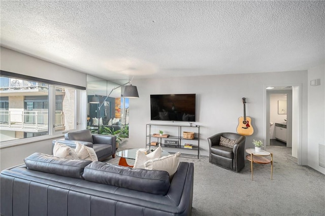 carpeted living room featuring a textured ceiling