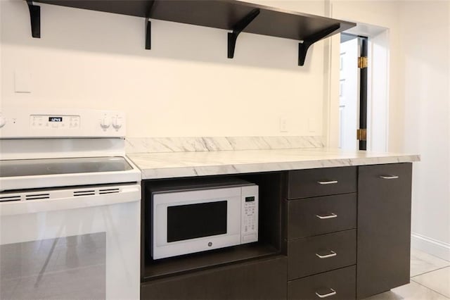 kitchen featuring white appliances and light tile patterned floors