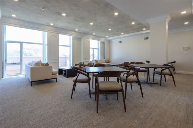 dining room with light carpet, plenty of natural light, and crown molding