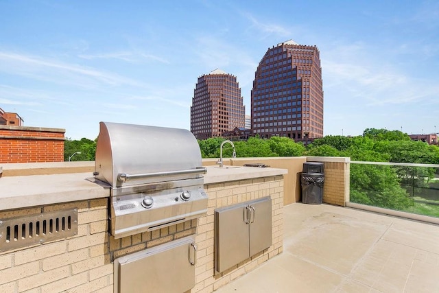 view of patio with area for grilling and an outdoor kitchen