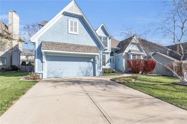 view of front of home with a front lawn and a garage