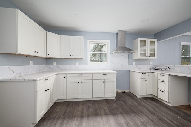 204 N 17th St, Leavenworth, KS 66048 - kitchen with wall chimney exhaust hood, dark wood-style flooring, glass insert cabinets, white cabinets, and decorative backsplash