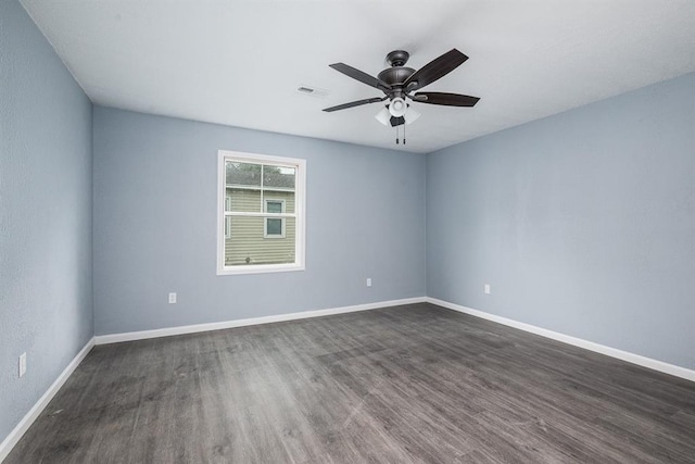 empty room with dark wood-type flooring and ceiling fan