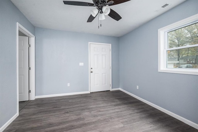 unfurnished room featuring ceiling fan and dark hardwood / wood-style flooring