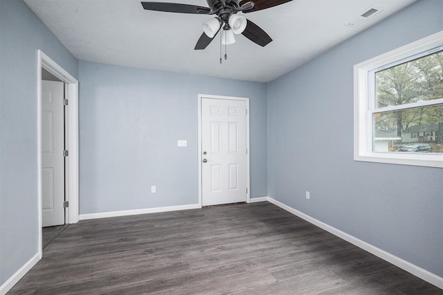 204 N 17th St, Leavenworth, KS 66048 - spare room featuring baseboards, dark wood-type flooring, and a ceiling fan
