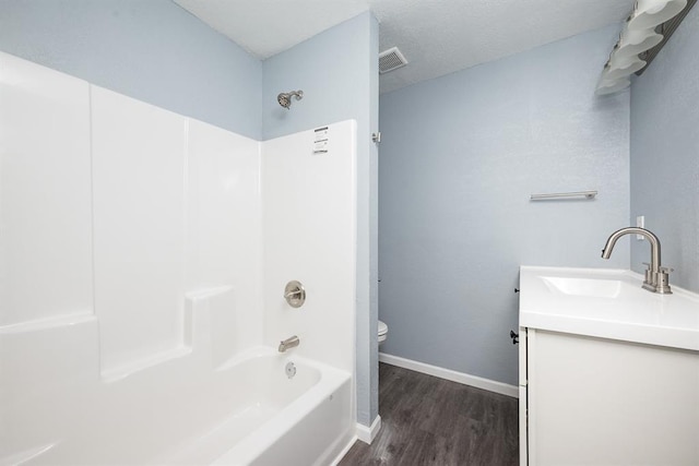 204 N 17th St, Leavenworth, KS 66048 - bathroom featuring toilet, wood finished floors, vanity, bathtub / shower combination, and baseboards